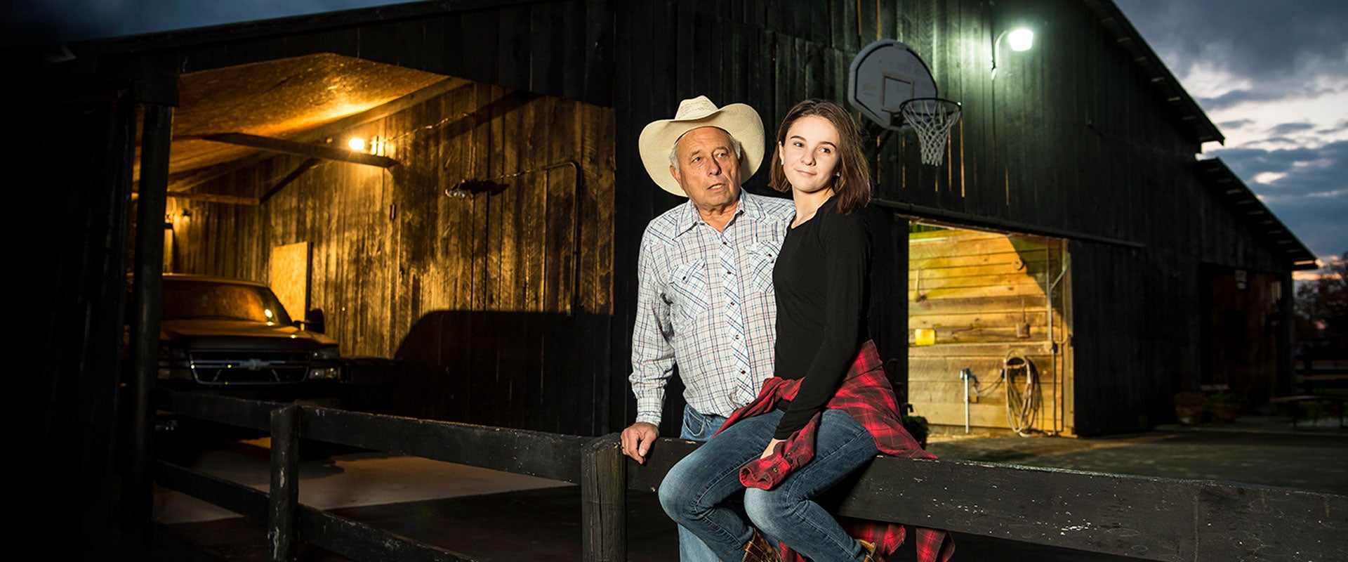 Grandfather and granddaughter working the farm